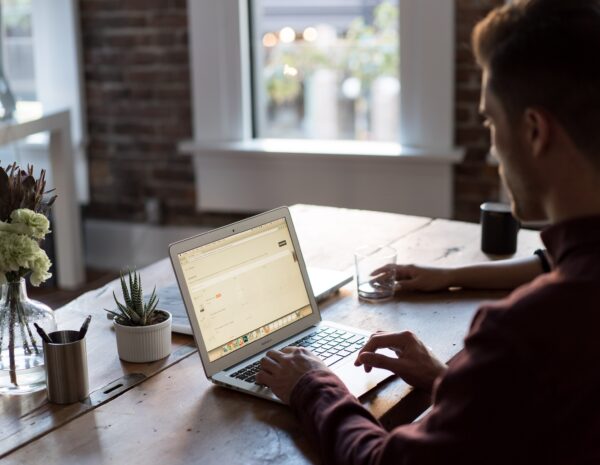 A man sits at a computer.